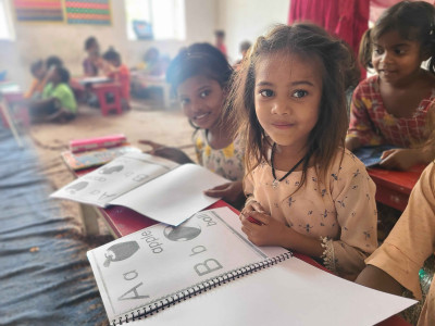 Children in India learning from textbooks