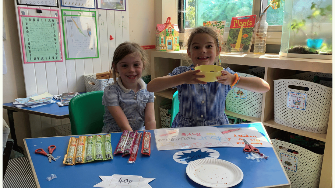 Year 1 students happily selling ice pops in their classroom